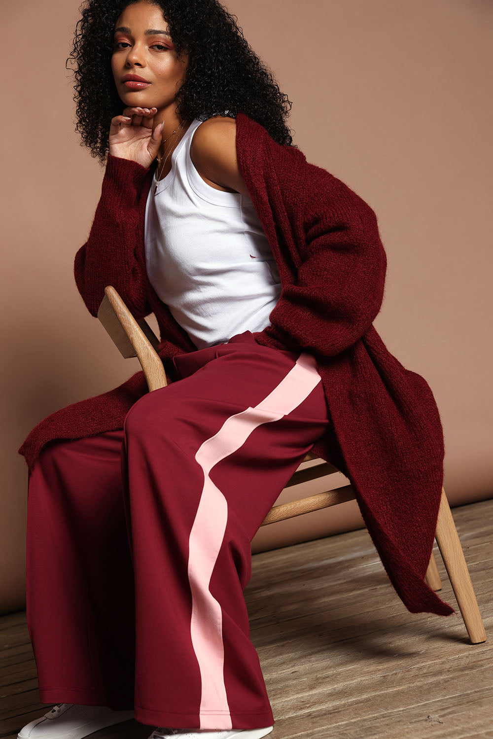 Model Ziara wearing size 10 of the Carmen Wide Leg Pant in colour Merlot (Red), from the front, showing the whole outfit