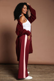 Model Ziara wearing size 10 of the Carmen Wide Leg Pant in colour Merlot (Red), from the front, showing the whole outfit