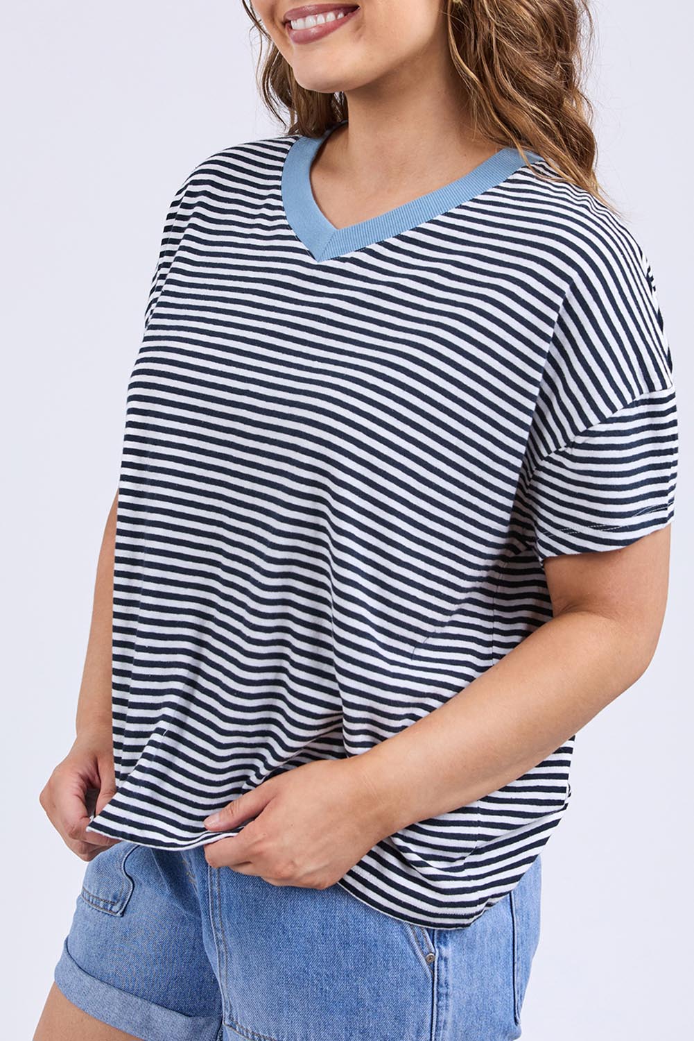 A model wearing the Liv Cotton Linen Vee Tee in colour Navywhite (Blue), from the front, cropped image
