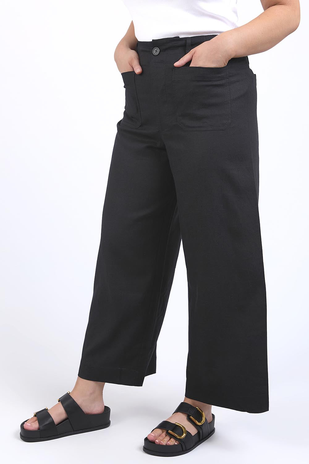 A model wearing the Wendy Pant in colour Black (Black), from the front, cropped image