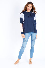 Model Ilona wearing size 10 of the Amelia Panel Hoody in colour Navycontr (Blue), from the front, showing the whole outfit