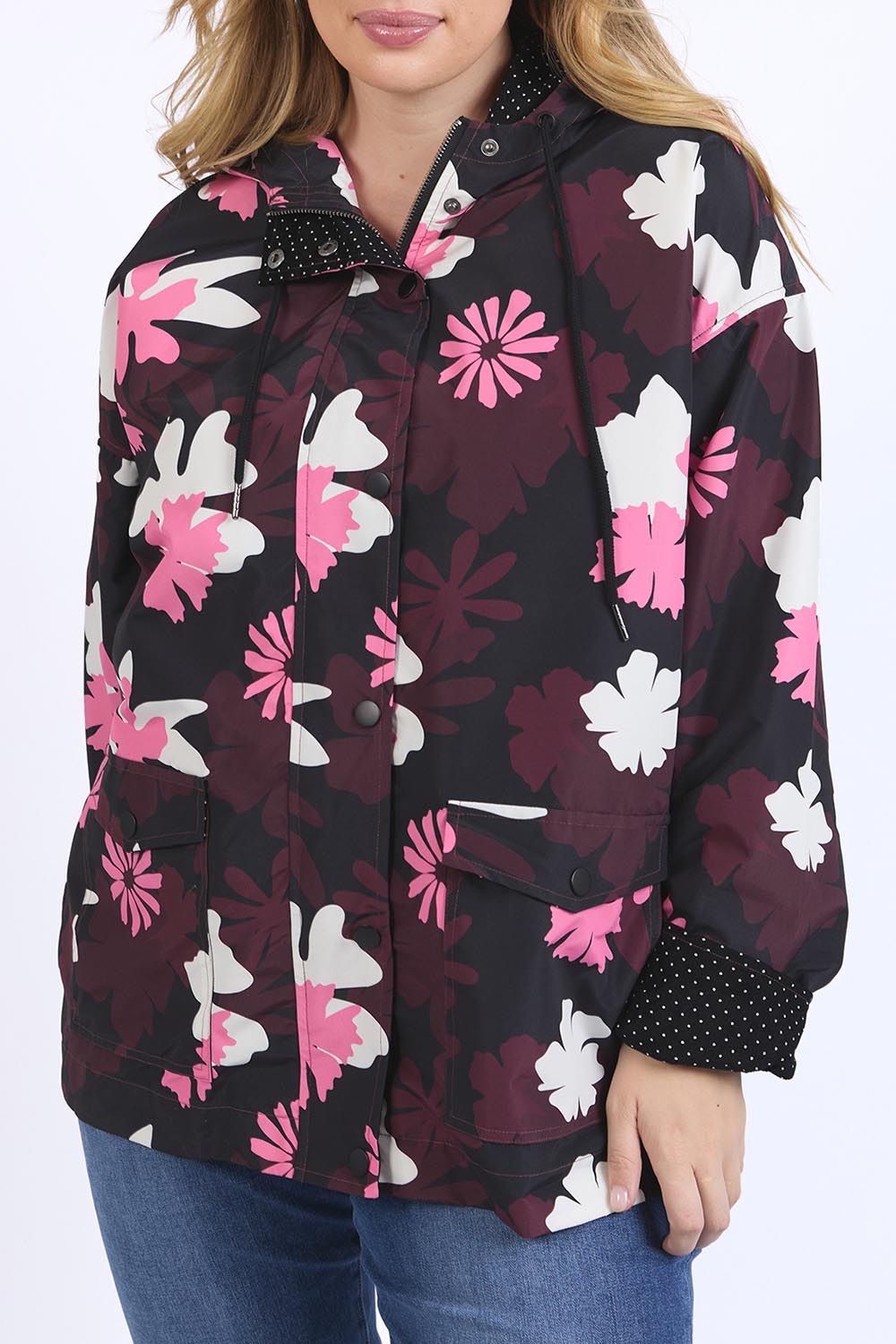 A model wearing the Hadley Floral Raincoat in colour Hadleyprin, from the front, cropped image
