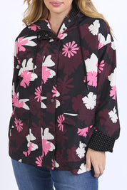 A model wearing the Hadley Floral Raincoat in colour Hadleyprin, from the front, cropped image