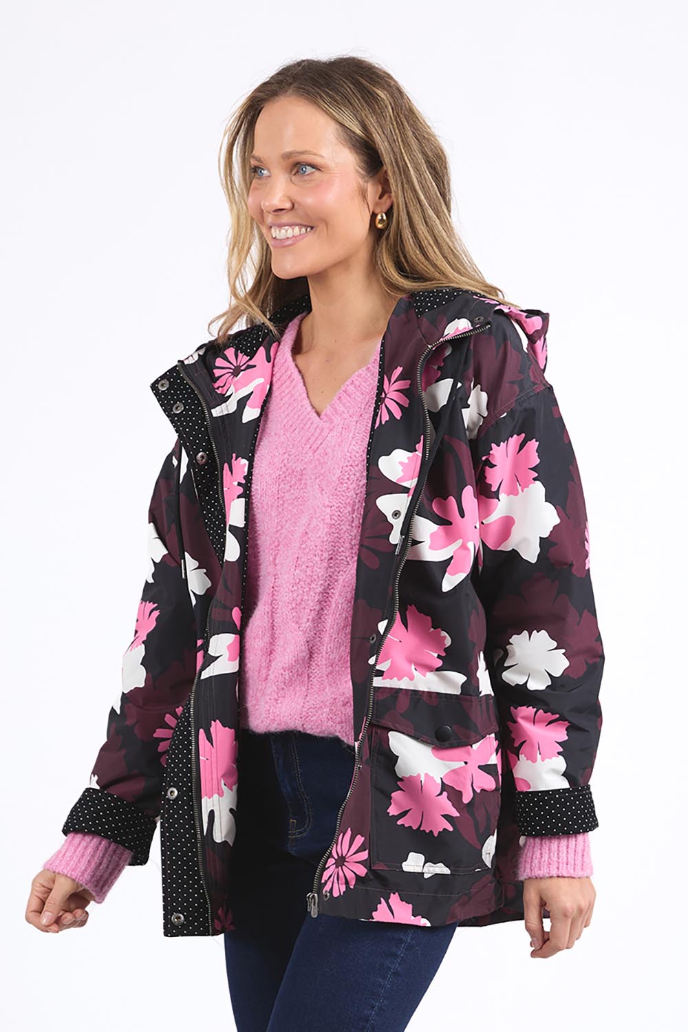 A model wearing the Hadley Floral Raincoat in colour Hadleyprin, from the front, cropped image