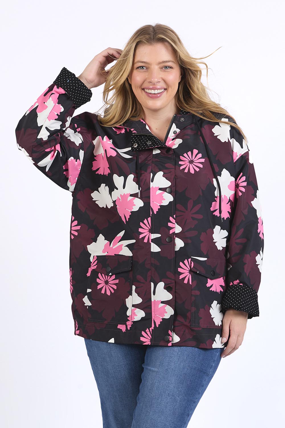 A model wearing the Hadley Floral Raincoat in colour Hadleyprin, from the front, cropped image