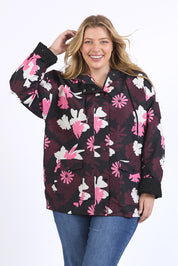 A model wearing the Hadley Floral Raincoat in colour Hadleyprin, from the front, cropped image