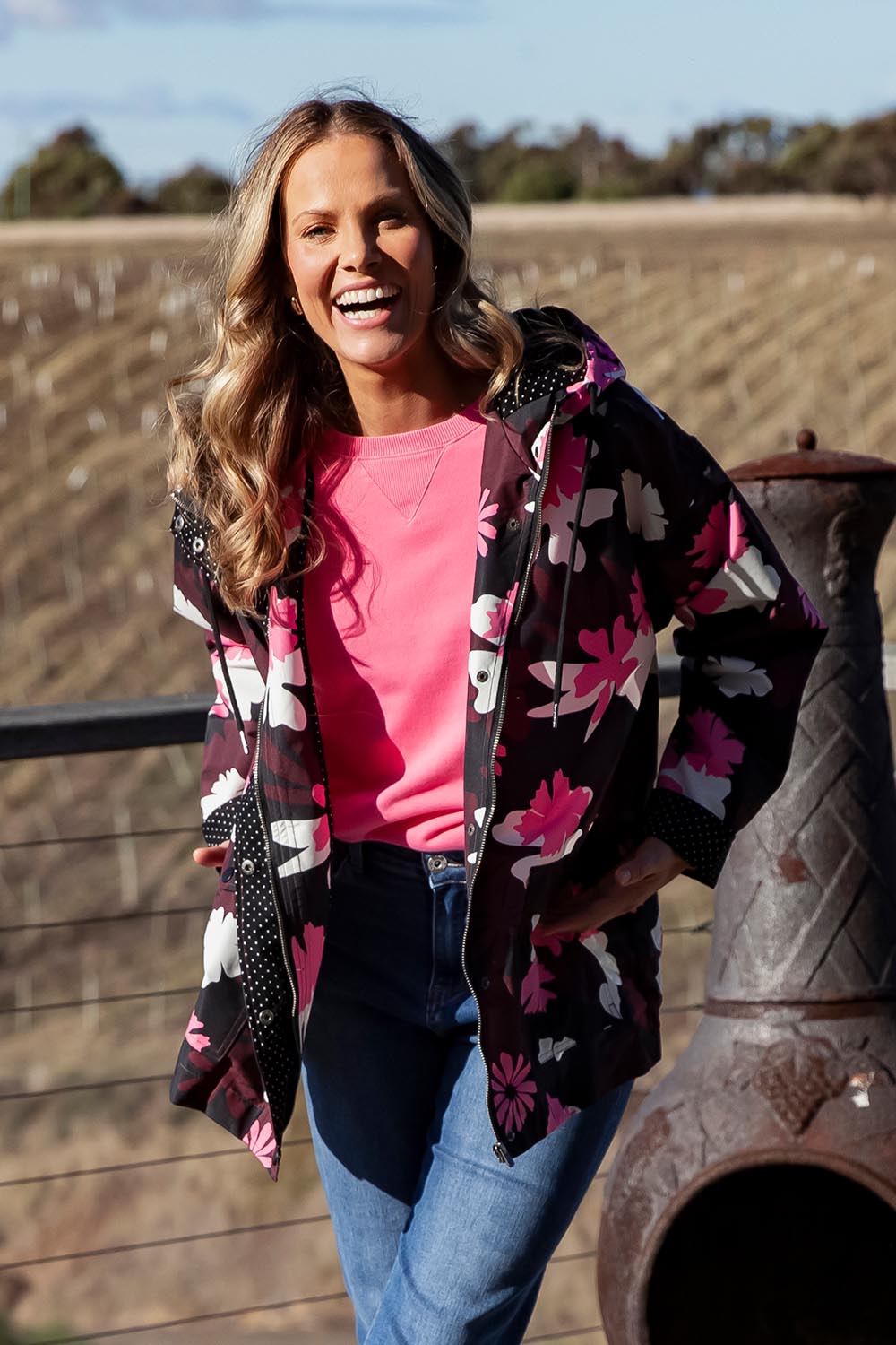 A model wearing the Hadley Floral Raincoat in colour Hadleyprin, from the front, showing the whole outfit