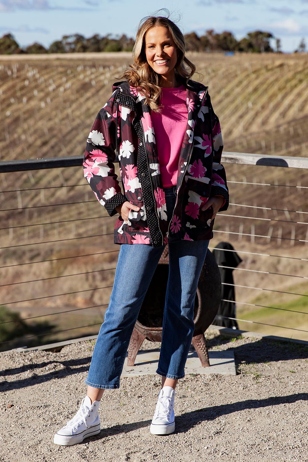 A model wearing the Hadley Floral Raincoat in colour Hadleyprin, from the front, showing the whole outfit