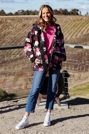 A model wearing the Hadley Floral Raincoat in colour Hadleyprin, from the front, showing the whole outfit