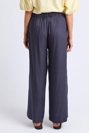A model wearing the Georgina Pant in colour Navy (Blue), from the back
