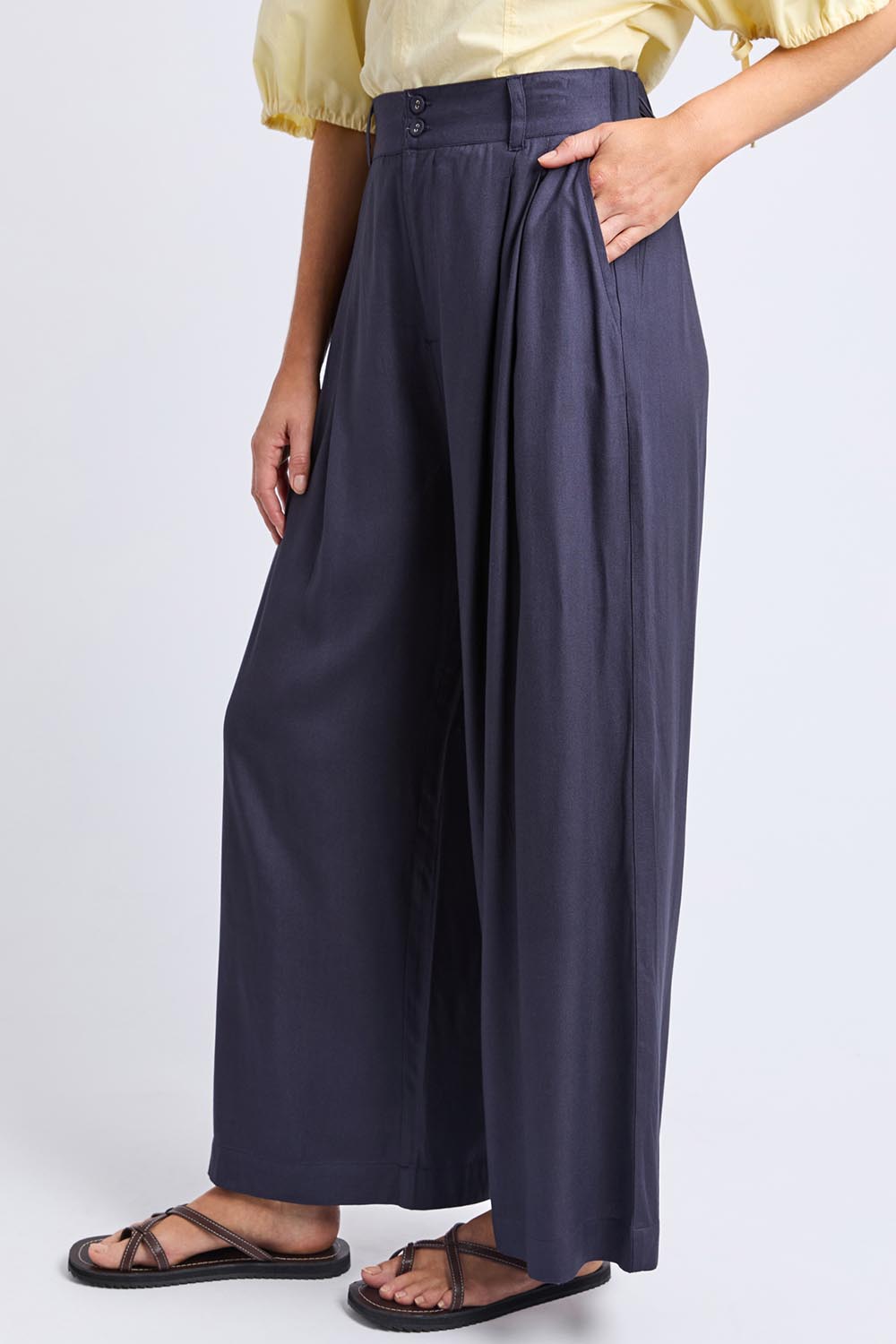 A model wearing the Georgina Pant in colour Navy (Blue), from the front, cropped image
