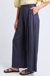 A model wearing the Georgina Pant in colour Navy (Blue), from the front, cropped image