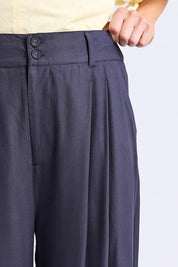 A model wearing the Georgina Pant in colour Navy (Blue), from the front, cropped image