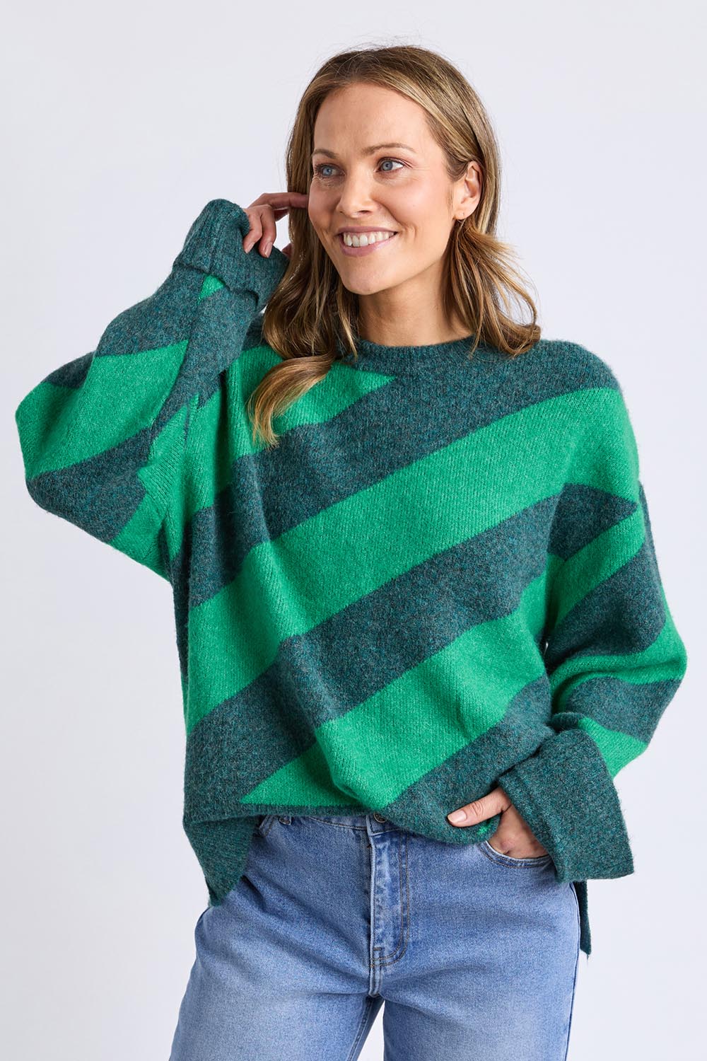 A model wearing the Sage Diagonal Stripe Knit in colour Turquoise (Green), from the front, cropped image