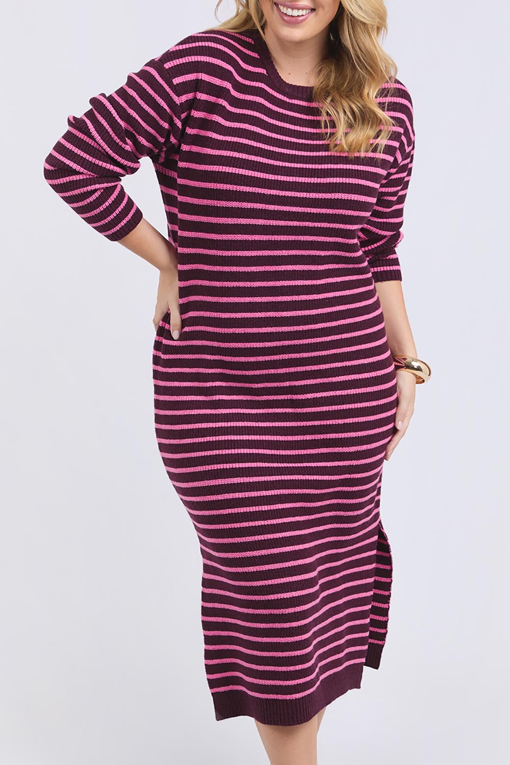 A model wearing the Tess Stripe Cashmere Blend Knit Dress in colour Merlotpink, from the front, cropped image