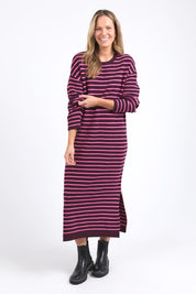 A model wearing the Tess Stripe Cashmere Blend Knit Dress in colour Merlotpink, from the front, showing the whole outfit