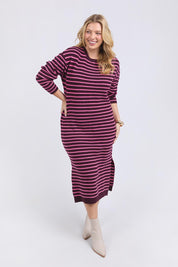 A model wearing the Tess Stripe Cashmere Blend Knit Dress in colour Merlotpink, from the front, showing the whole outfit