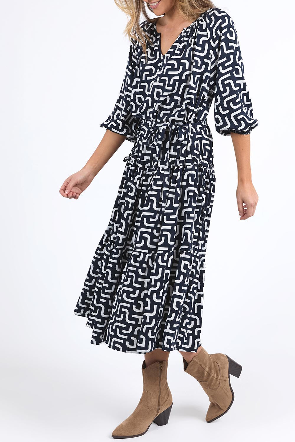 A model wearing the Gemma Geo Dress in colour Navygeo (Blue), from the front, cropped image