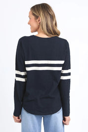 A model wearing the Adora Long Sleeve Cotton Tee in colour Darksapph (Blue), from the back