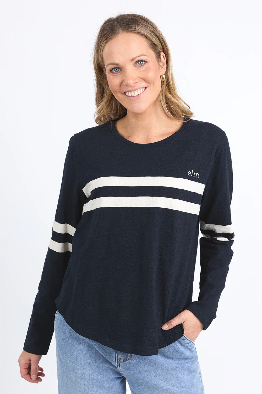 A model wearing the Adora Long Sleeve Cotton Tee in colour Darksapph (Blue), from the front, cropped image