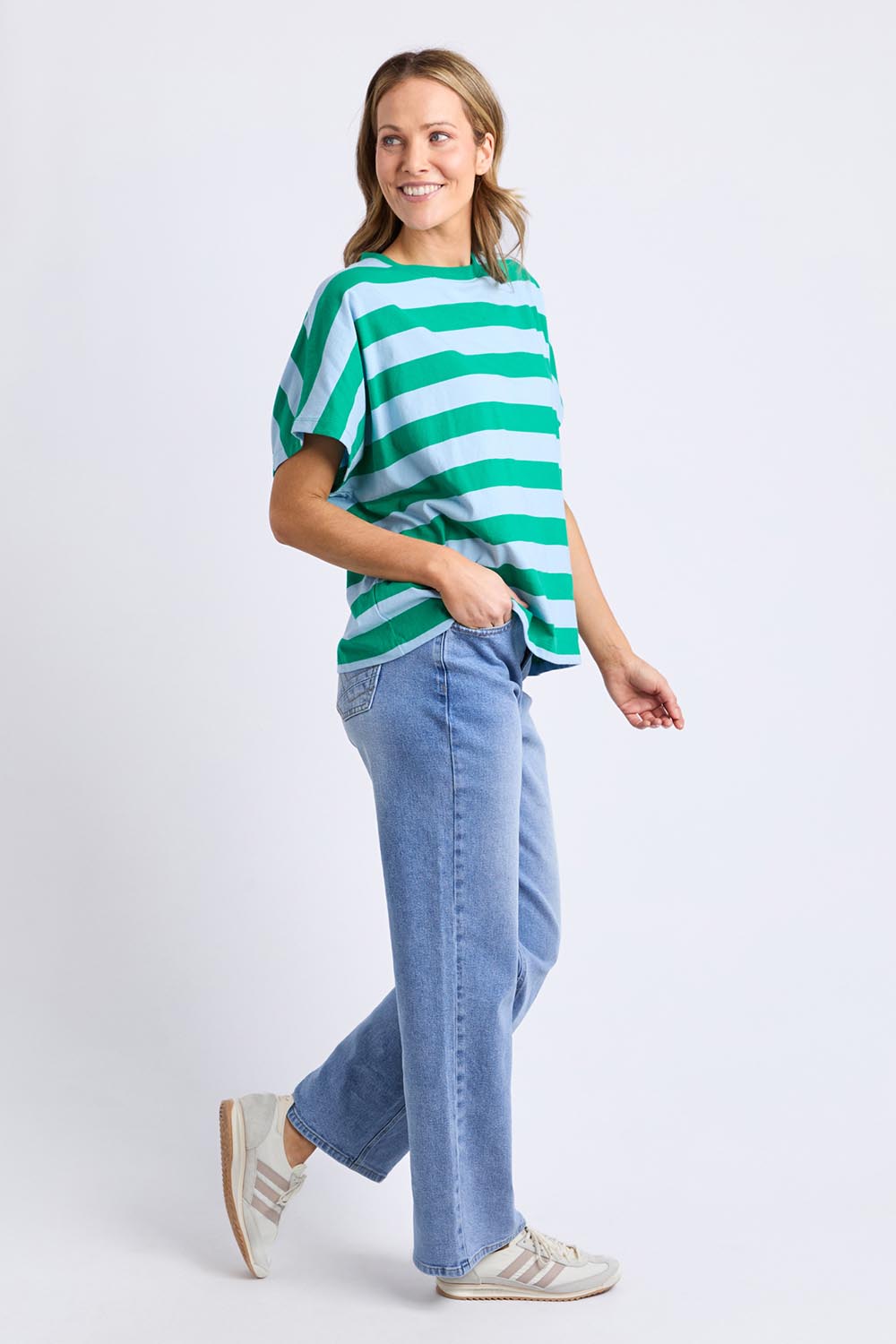 A model wearing the Poet Cotton Tee in colour Greenblue, from the front, showing the whole outfit