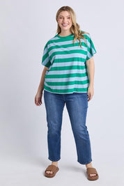 A model wearing the Poet Cotton Tee in colour Greenblue, from the front, showing the whole outfit