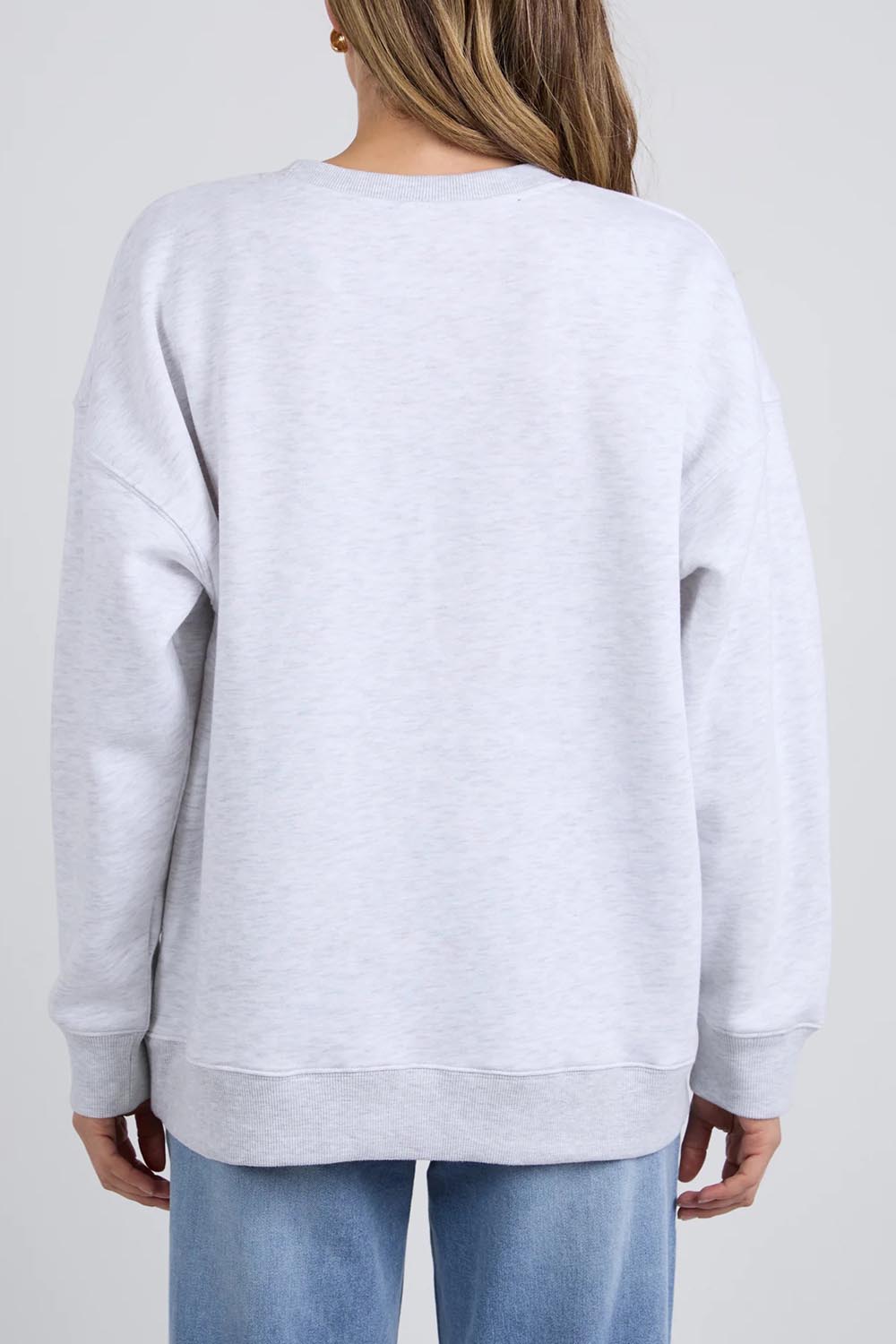 A model wearing the Emblem Cotton Crew in colour Greymarle (Grey), from the back