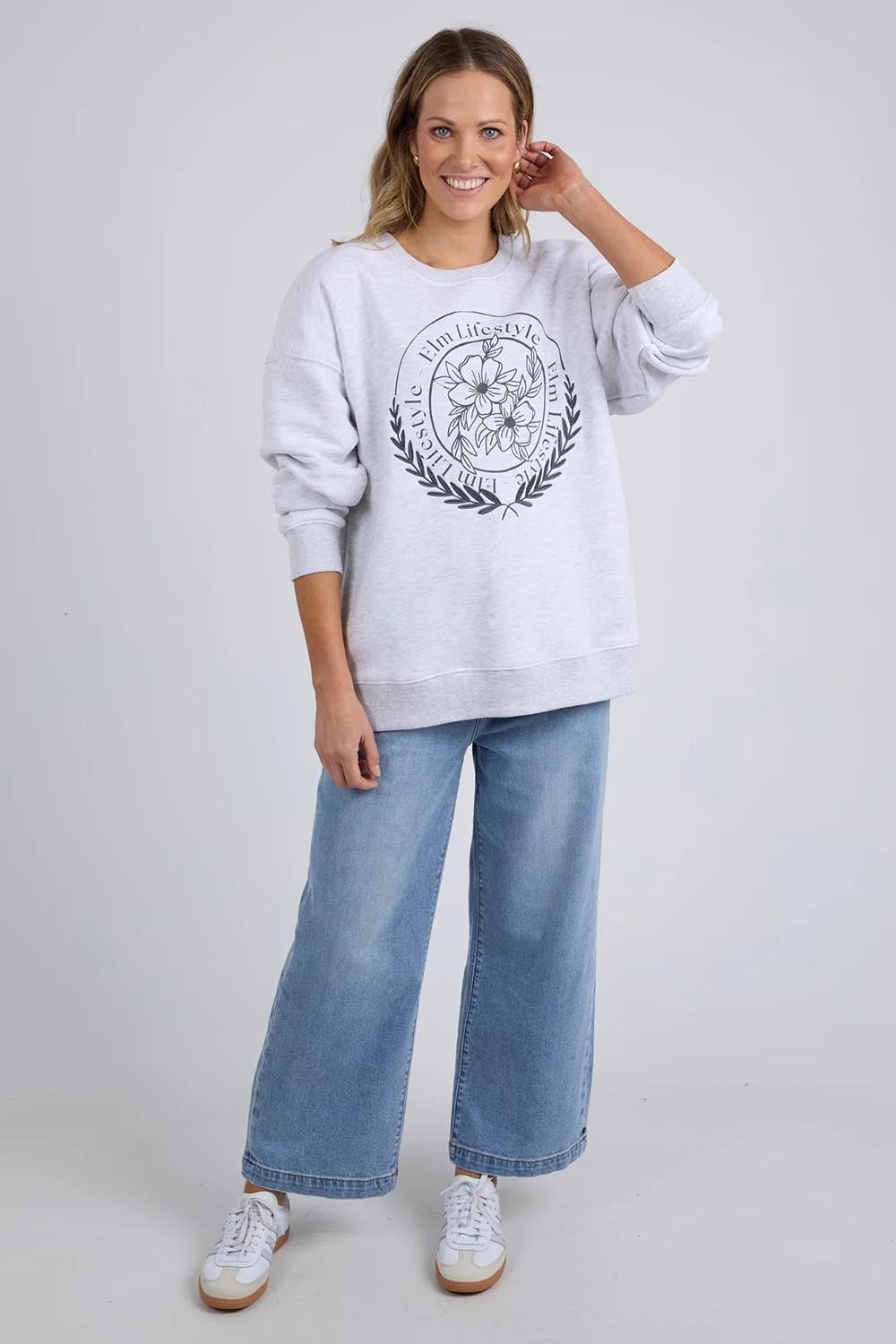A model wearing the Emblem Cotton Crew in colour Greymarle (Grey), from the front, showing the whole outfit