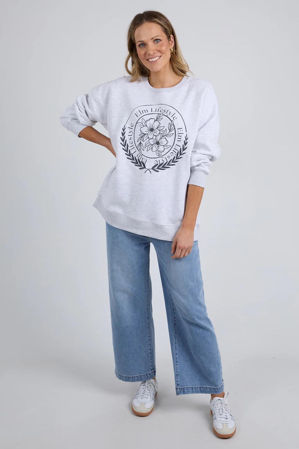 A model wearing the Emblem Cotton Crew in colour Greymarle (Grey), from the front, showing the whole outfit