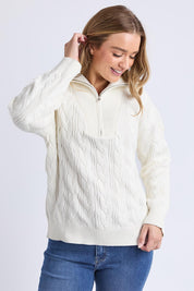 A model wearing the Zalie Zip Cotton Knit in colour Marshmello, from the front, cropped image
