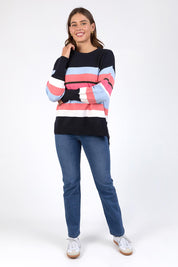 A model wearing the Lacey Stripe Knit in colour Navypink, from the front, showing the whole outfit