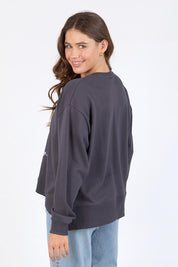 A model wearing the Tulip Cotton Crew in colour Washblack (Black), from the back