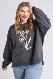 A model wearing the Tulip Cotton Crew in colour Washblack (Black), from the front, cropped image
