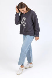 A model wearing the Tulip Cotton Crew in colour Washblack (Black), from the front, showing the whole outfit