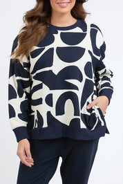 A model wearing the Mural Cotton Crew in colour Navy, from the front, cropped image