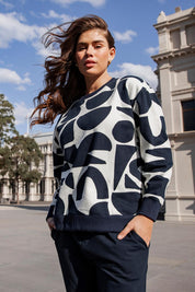 A model wearing the Mural Cotton Crew in colour Navy, from the front, showing the whole outfit