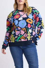 A model wearing the Flower Medley Cotton Crew in colour Multiflora, from the front, cropped image