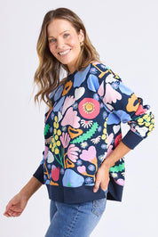 A model wearing the Flower Medley Cotton Crew in colour Multiflora, from the front, cropped image