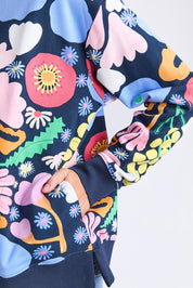 A model wearing the Flower Medley Cotton Crew in colour Multiflora, from the front, cropped image