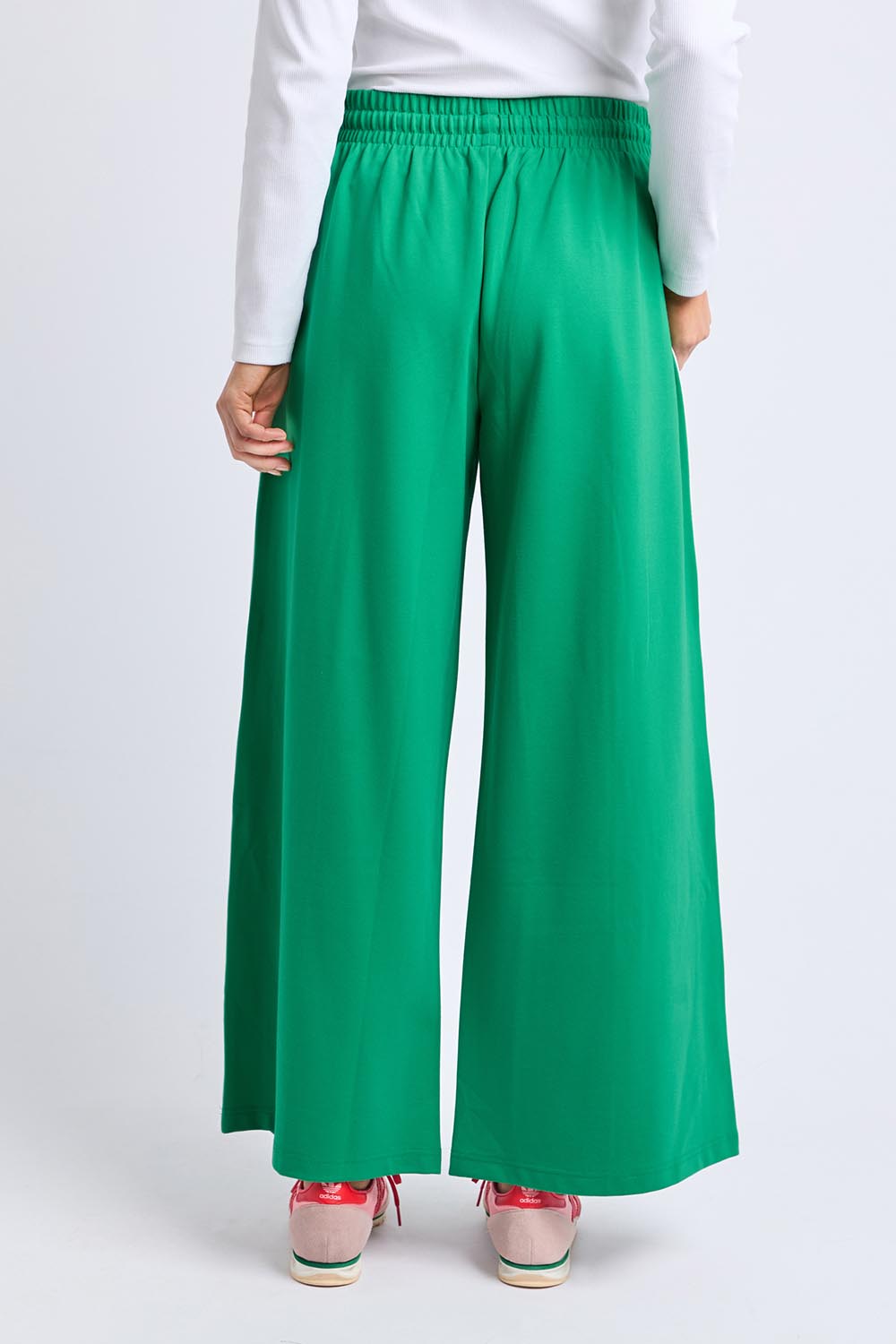 A model wearing the Carmen Wide Leg Pant in colour Pinegreen (Green), from the back