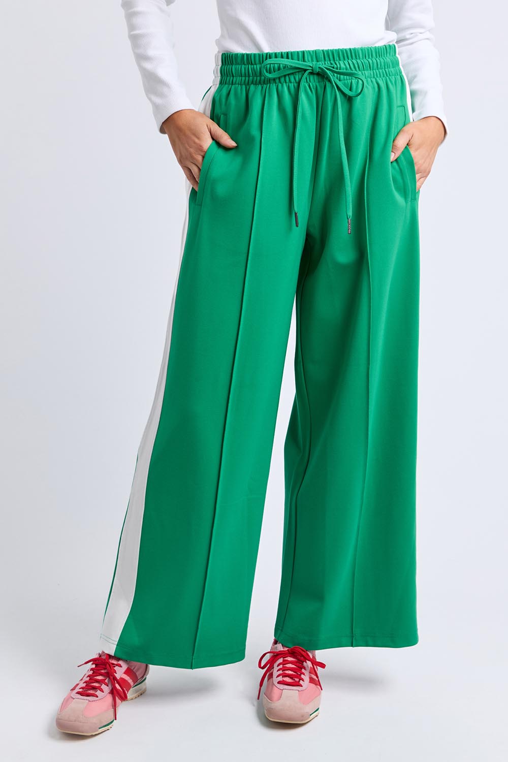 A model wearing the Carmen Wide Leg Pant in colour Pinegreen (Green), from the front, cropped image