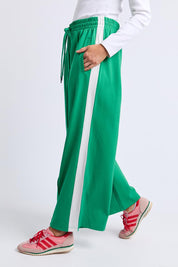 A model wearing the Carmen Wide Leg Pant in colour Pinegreen (Green), from the front, cropped image