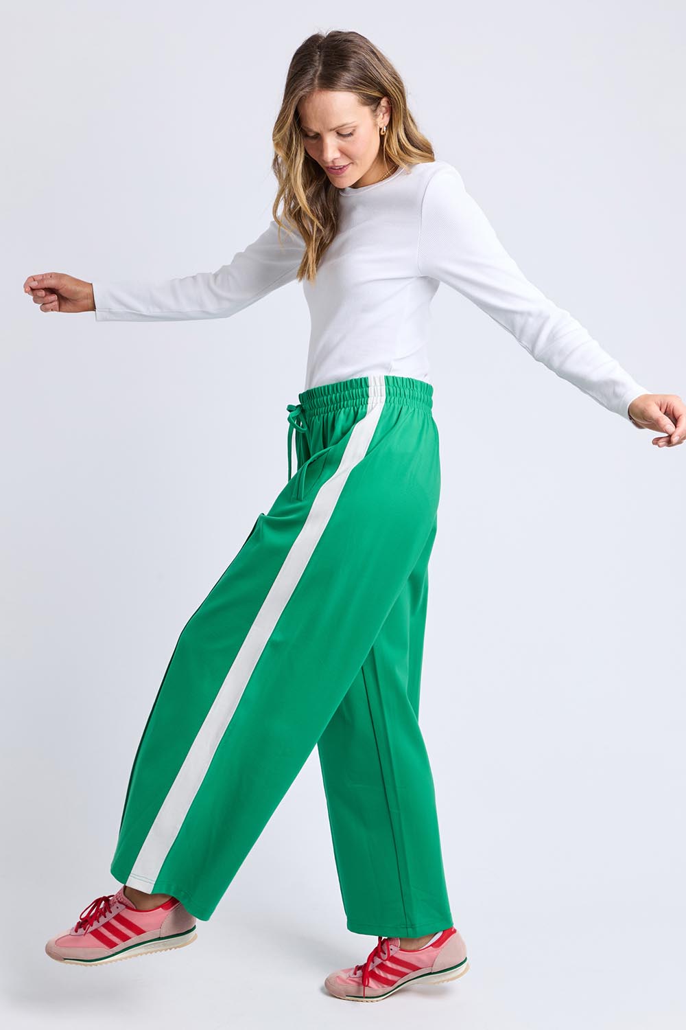 A model wearing the Carmen Wide Leg Pant in colour Pinegreen (Green), from the front, showing the whole outfit