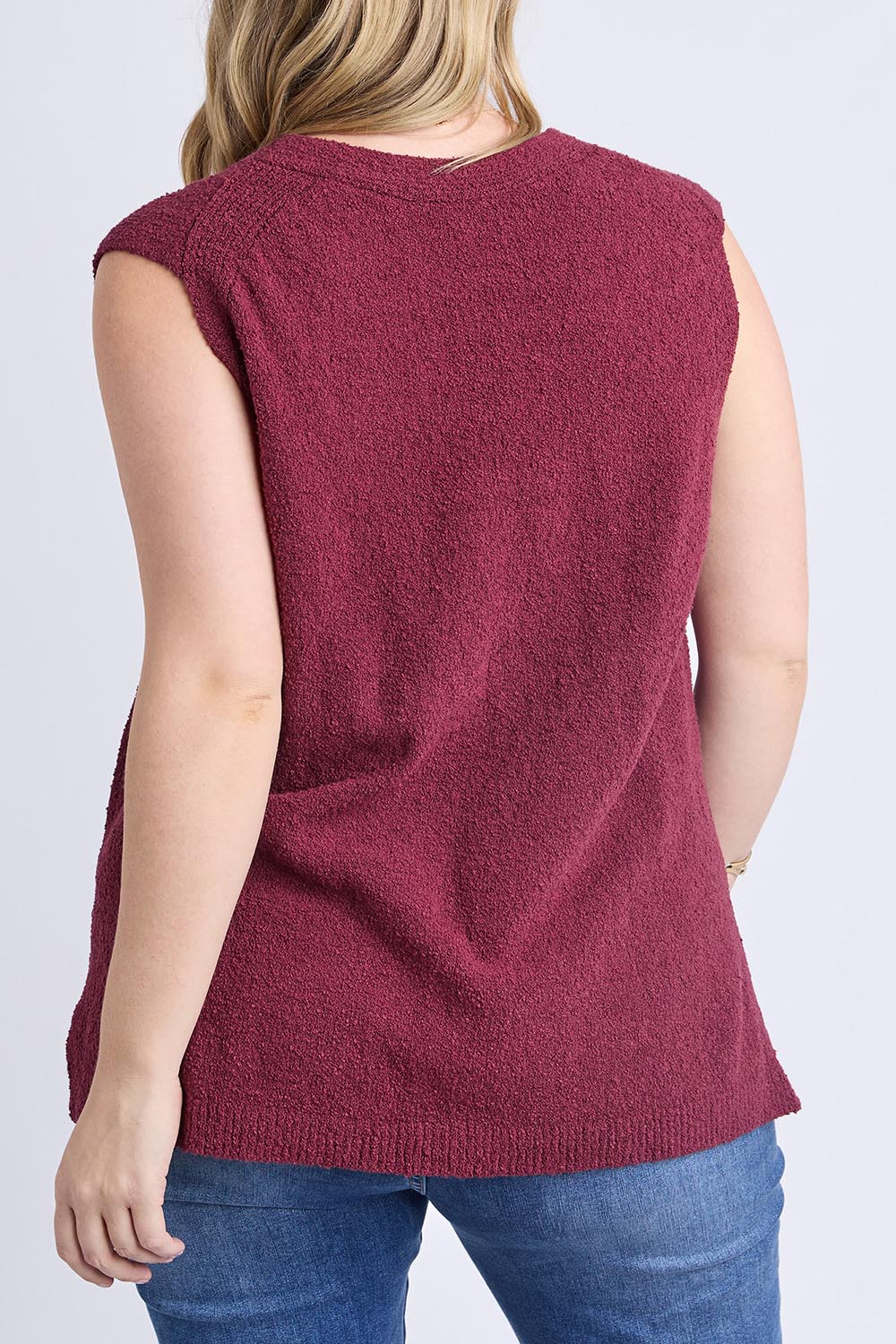 A model wearing the Bowie Cotton Blend Knit Vest in colour Plum (Red), from the back