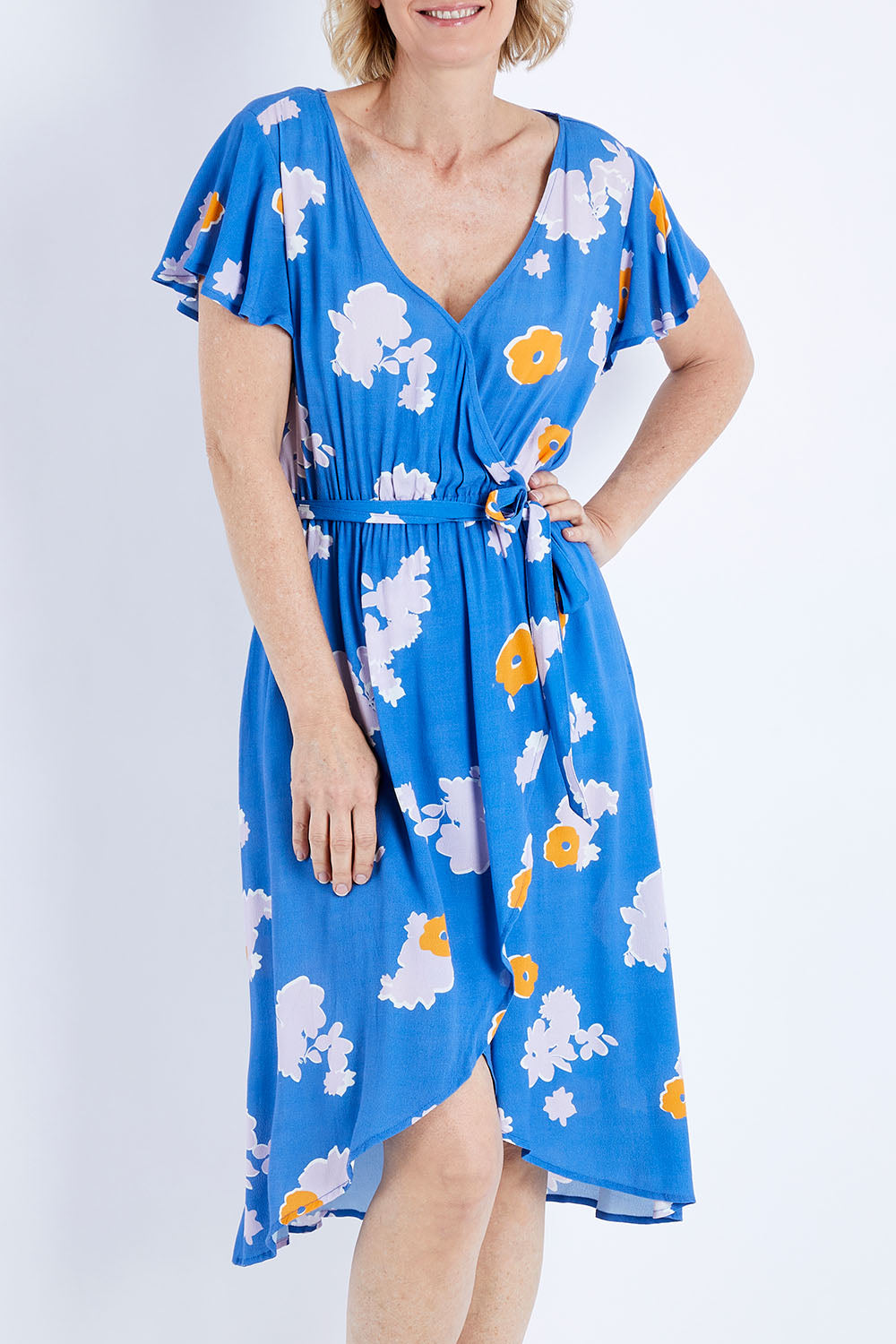 Model Veronica wearing size 10 of the Petal Floral Wrap Dress in colour Petal (Blue), from the front, cropped image