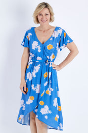 Model Veronica wearing size 10 of the Petal Floral Wrap Dress in colour Petal (Blue), from the front, cropped image