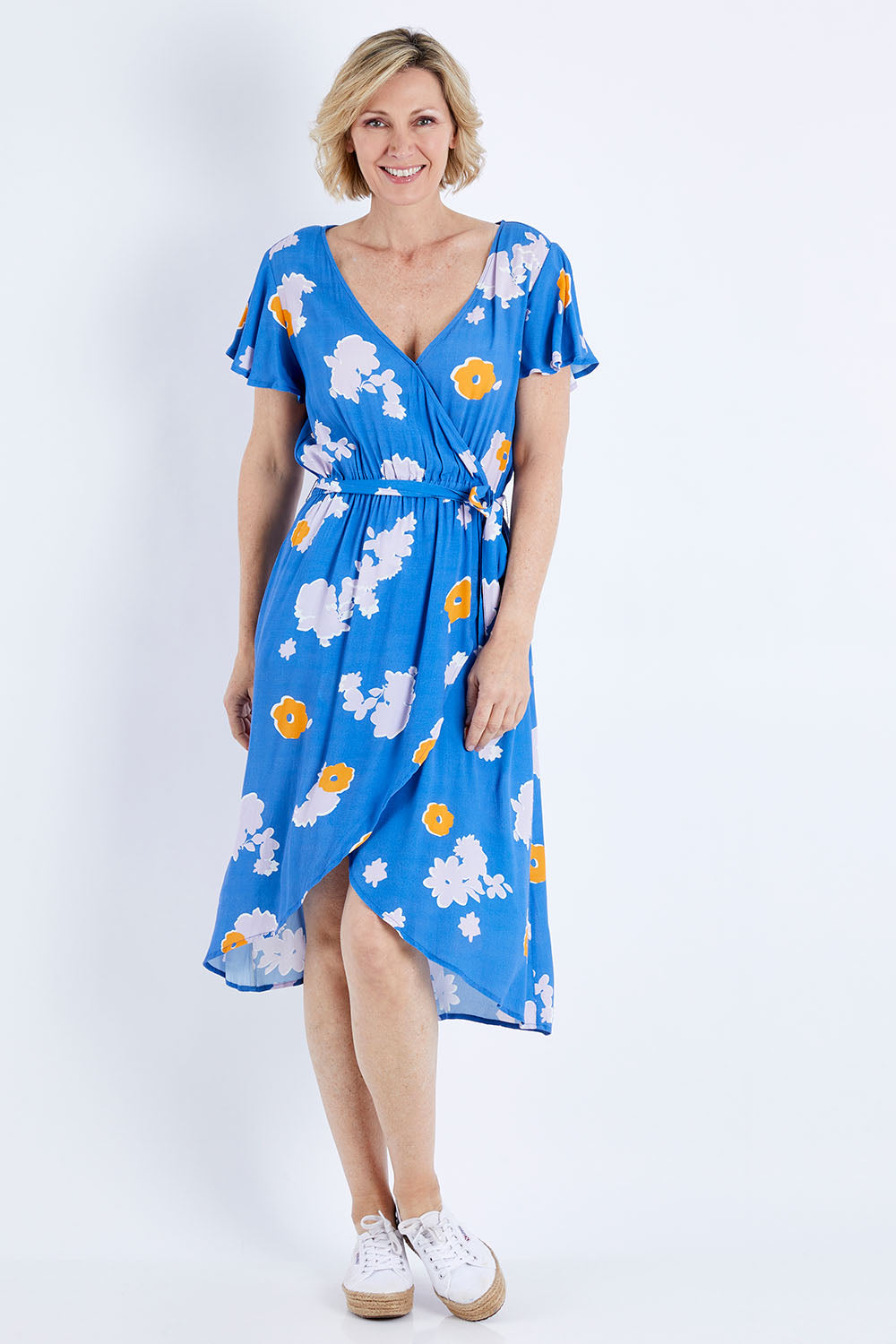 Model Veronica wearing size 10 of the Petal Floral Wrap Dress in colour Petal (Blue), from the front, showing the whole outfit