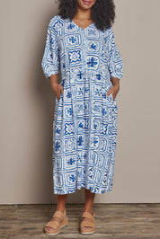 Model Ziara wearing size 10 of the Dolce Tile Cotton Blend Midi Dress in colour Oceantile (Blue), from the front, cropped image