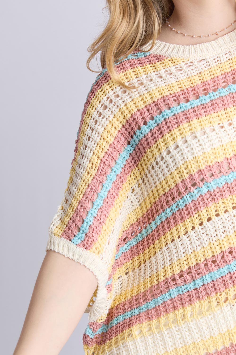 A model wearing the Striped Knit Top in colour Bluestripe, from the front, cropped image
