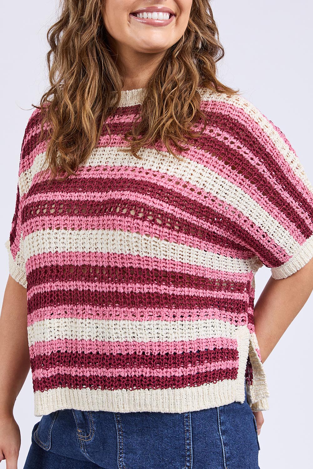 A model wearing the Striped Knit Top in colour Chateauros, from the front, cropped image